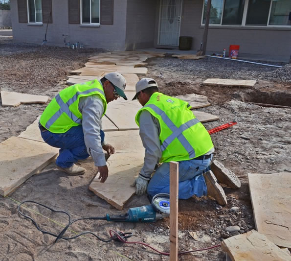 Photo of Landscape Contractor in Las Vegas installing Landscape pavers in backyard