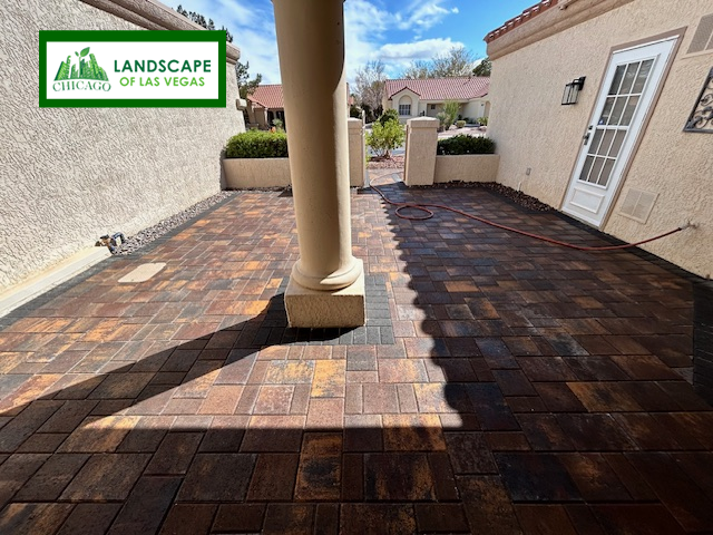 Custom earth-tone paver patio installation with charcoal border in Henderson, NV courtyard by Chicago Landscape of Las Vegas.