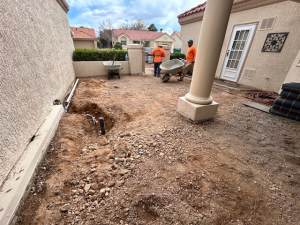 Custom earth-tone paver patio installation with charcoal border in Henderson, NV courtyard by Chicago Landscape of Las Vegas.