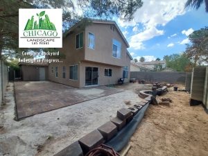 In progress photo showing pavers and retaining walls being constructed.