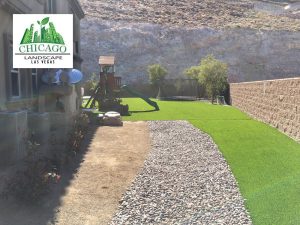 Southern Highlands backyard with landscape rocks and artificial turf installation