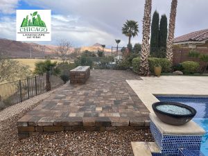 Completed Lake Las Vegas pool deck extension with landscape pavers, custom fire feature, and rock accents