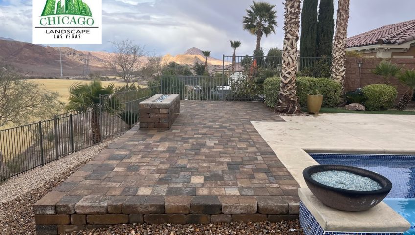 Completed Lake Las Vegas pool deck extension with landscape pavers, custom fire feature, and rock accents