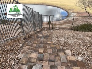Paver staircase at a Lake Las Vegas pool deck extension overlooking a golf course gate and pond