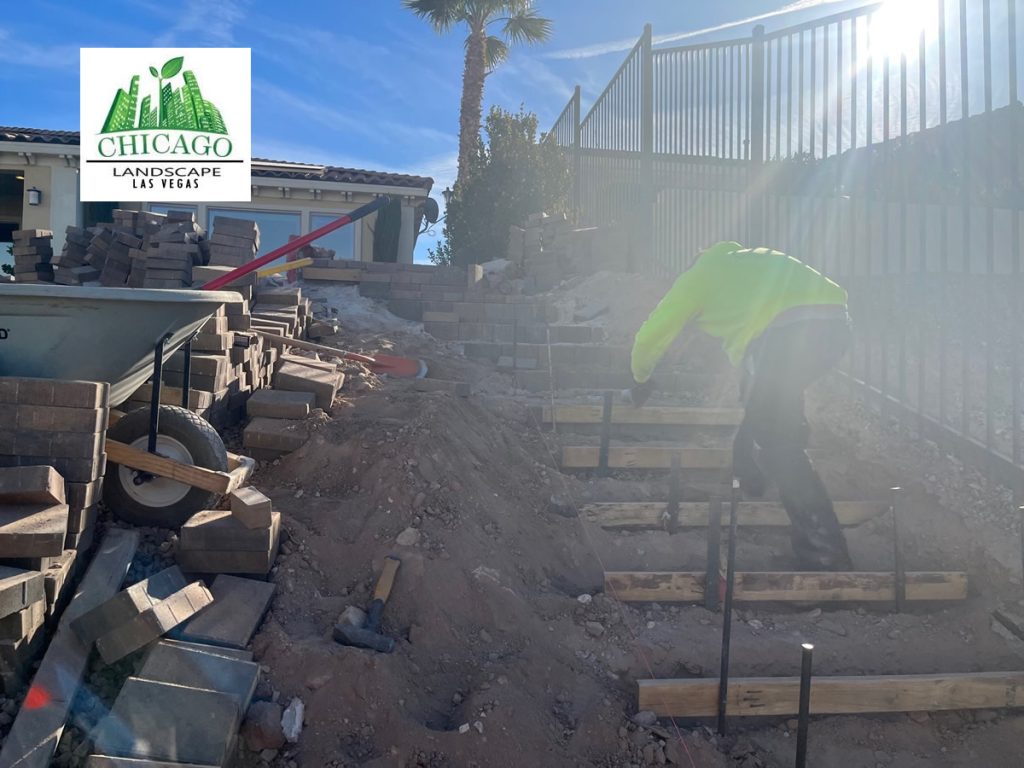 Chicago Landscape of Las Vegas workers building paver steps for a Lake Las Vegas pool deck extension near a golf course gate