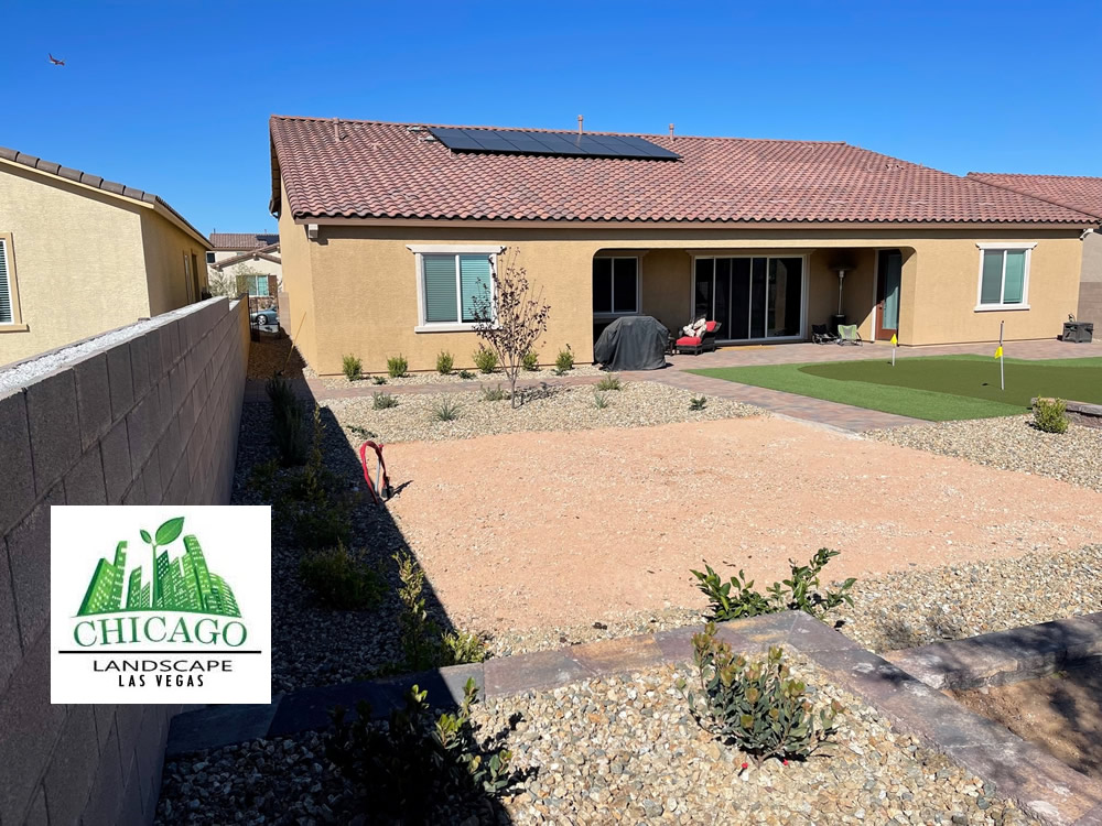 Completed Las Vegas backyard landscape redesign with custom putting green, artificial turf, paver patio, raised planting beds, decorative rock, and drought-tolerant landscaping.