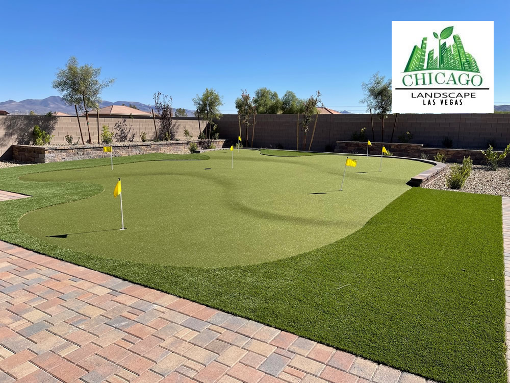 Completed Las Vegas backyard landscape redesign with custom putting green, artificial turf, paver patio, raised planting beds, decorative rock, and drought-tolerant landscaping.