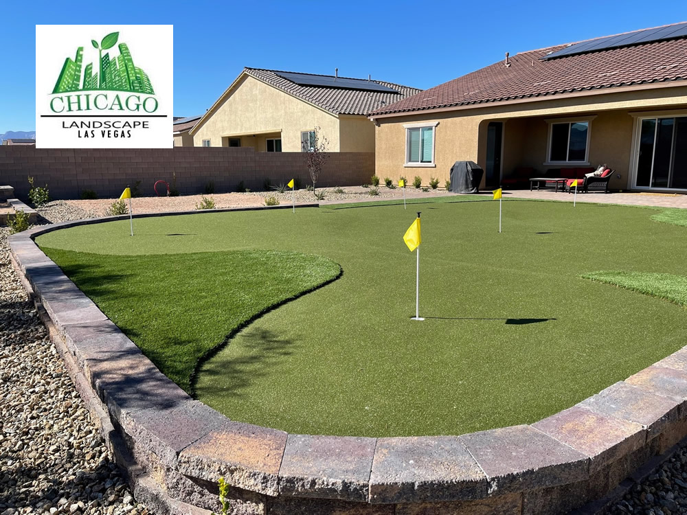 Completed Las Vegas backyard landscape redesign with custom putting green, artificial turf, paver patio, raised planting beds, decorative rock, and drought-tolerant landscaping.