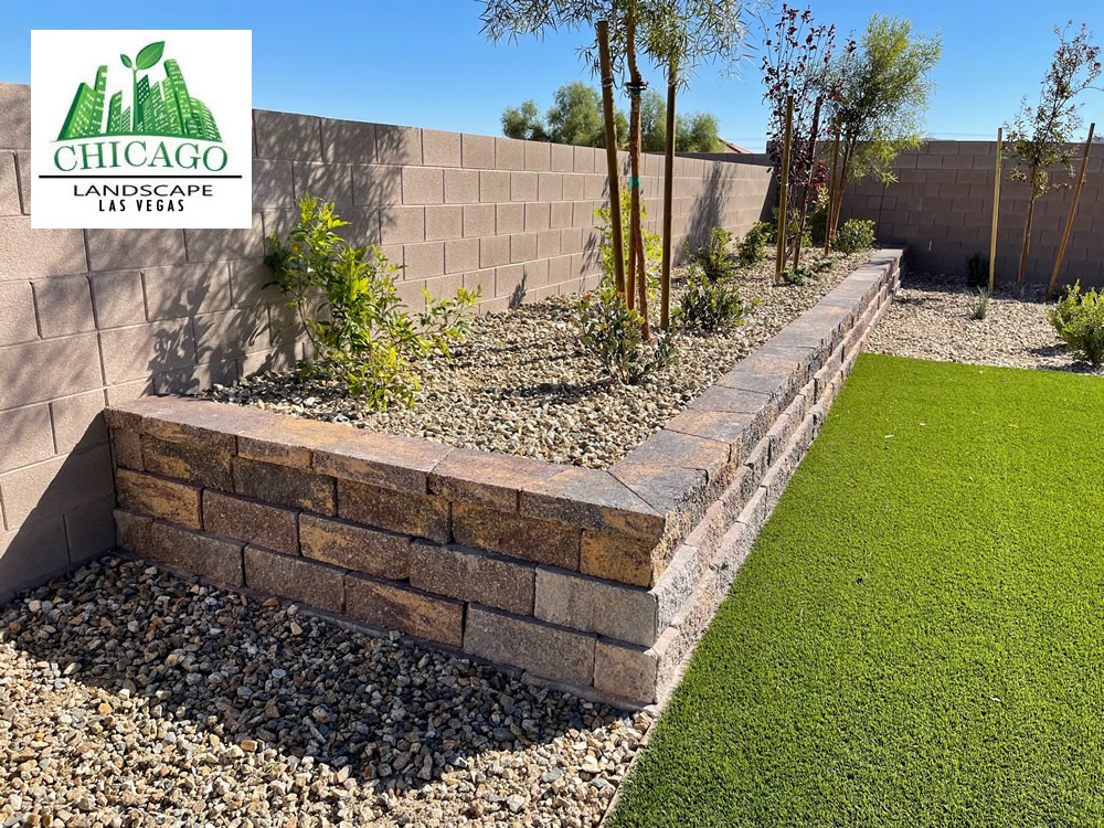 Completed Las Vegas backyard landscape redesign with custom putting green, artificial turf, paver patio, raised planting beds, decorative rock, and drought-tolerant landscaping.