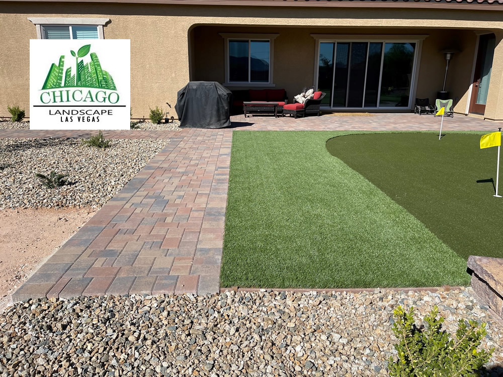 Completed Las Vegas backyard landscape redesign with custom putting green, artificial turf, paver patio, raised planting beds, decorative rock, and drought-tolerant landscaping.