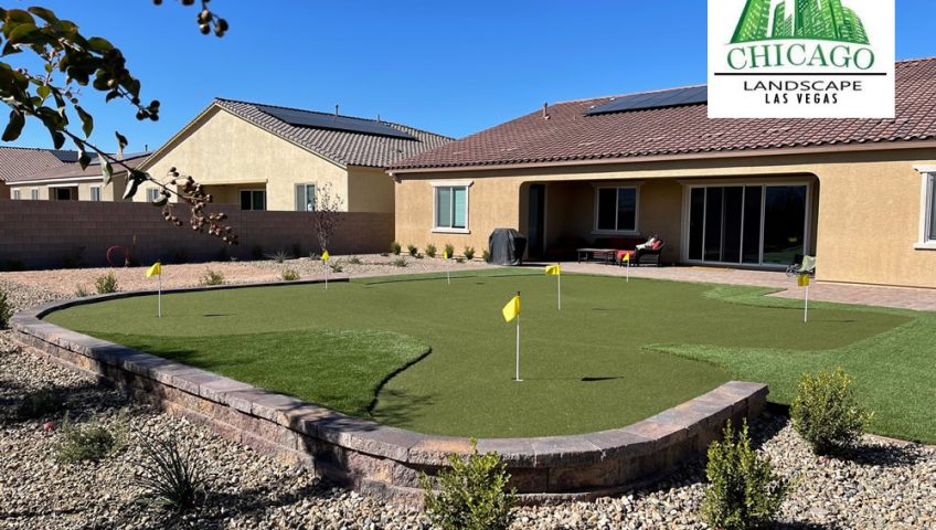 Completed Las Vegas backyard landscape redesign with custom putting green, artificial turf, paver patio, raised planting beds, decorative rock, and drought-tolerant landscaping.