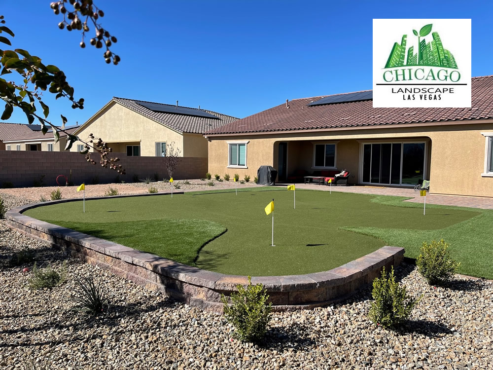 Completed Las Vegas backyard landscape redesign with custom putting green, artificial turf, paver patio, raised planting beds, decorative rock, and drought-tolerant landscaping.