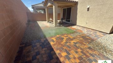 Completed Las Vegas backyard desert conversion with a multicolored paver patio, small lawn, and landscape rock.