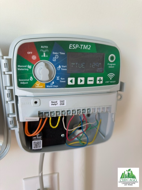 New Rain Bird ESP-TM2 irrigation controller mounted on a wall with the cover open.