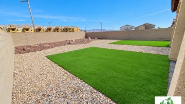 Green Valley backyard redesign with artificial turf, paver stepping pads, and contrasting landscape rock.